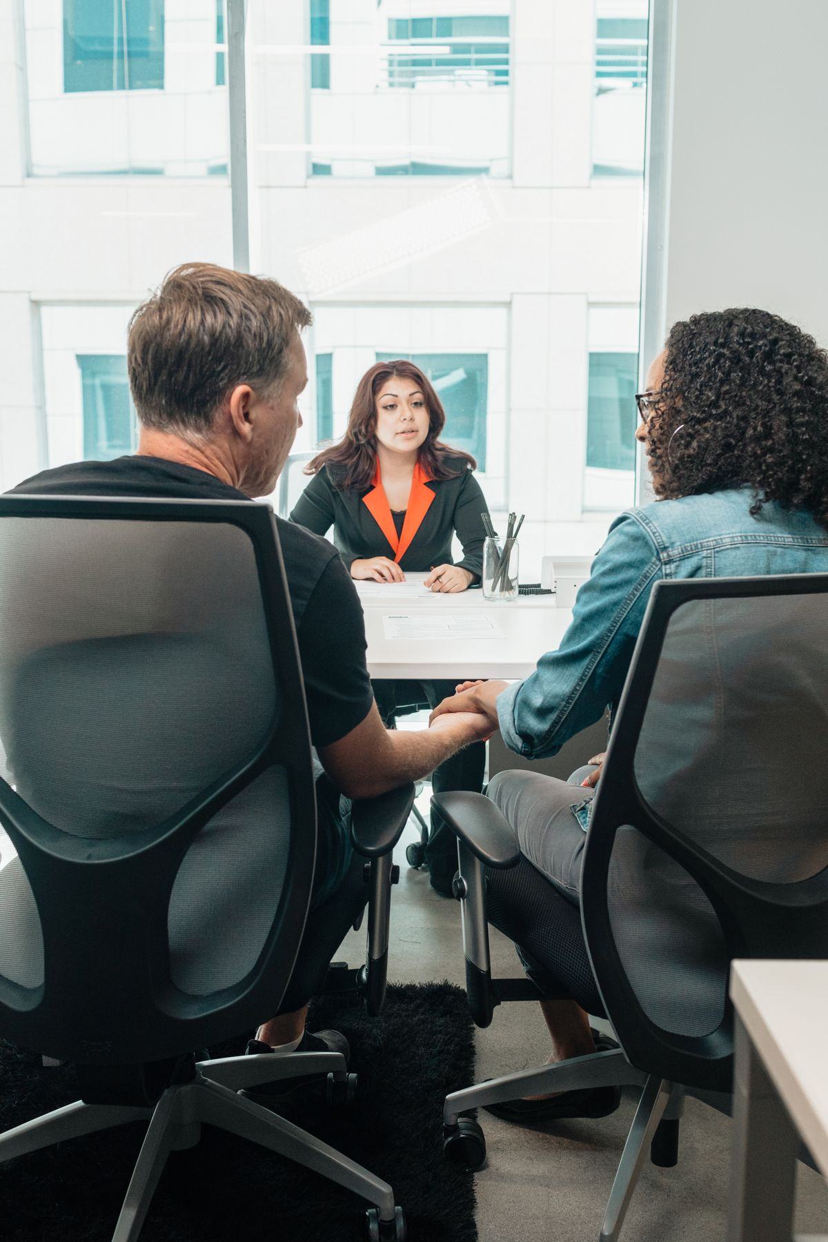An advisor meeting with a couple across a desk