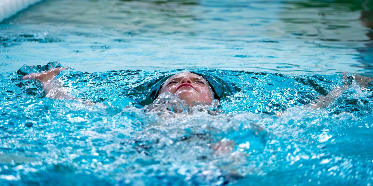 A swimmer gliding through clear blue water